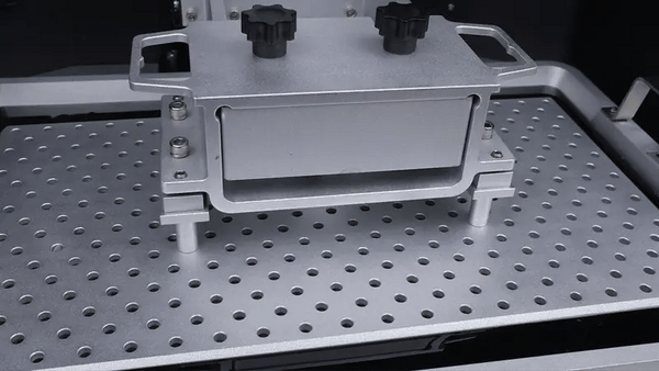 A picture of a resin build plate going down on a vat filled with resin showing how to speed up 3D prints.