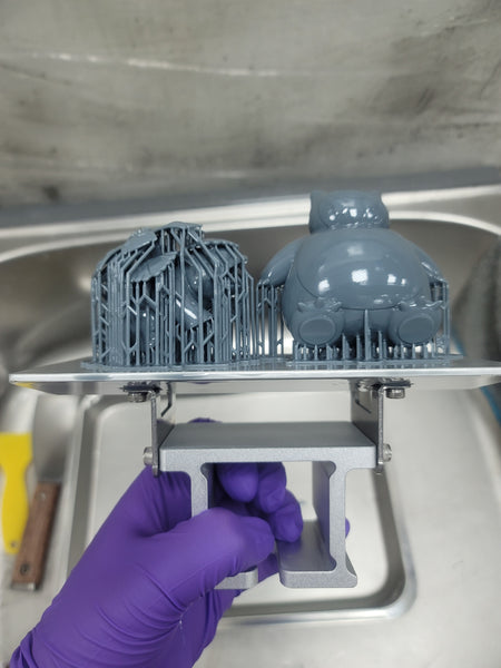 A picture showing two 3D models with supports on a build plate.