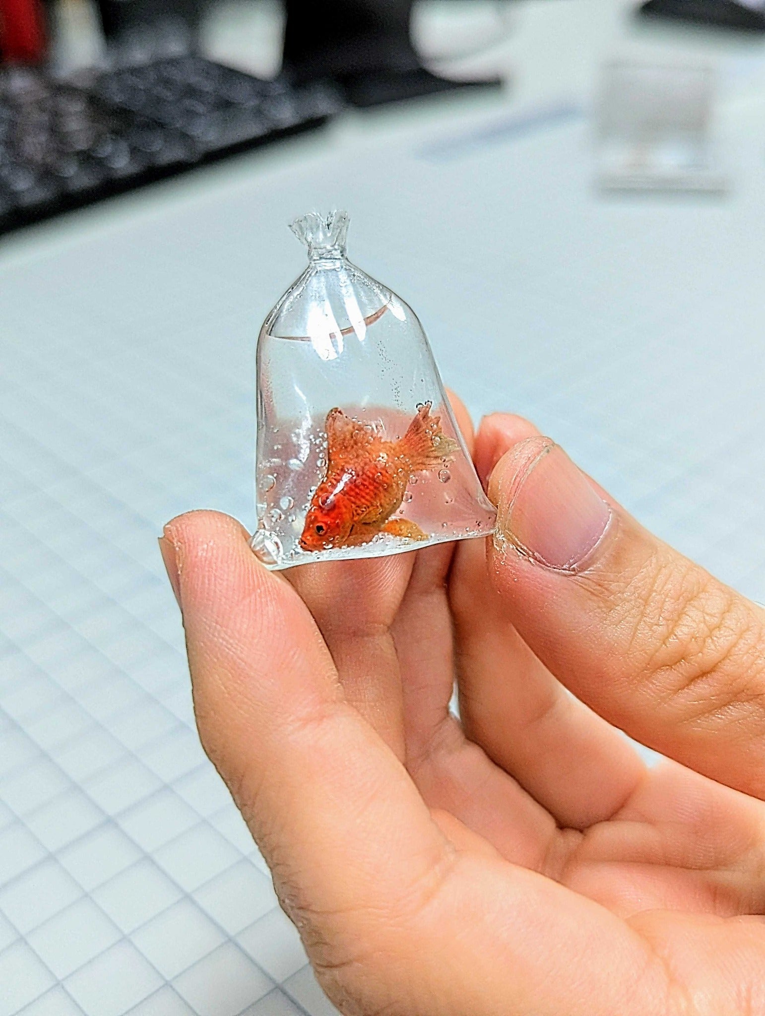 A picture of a golden fish inside a plastic bag 3D model created using the Phrozen Aqua Clear Plus Resin