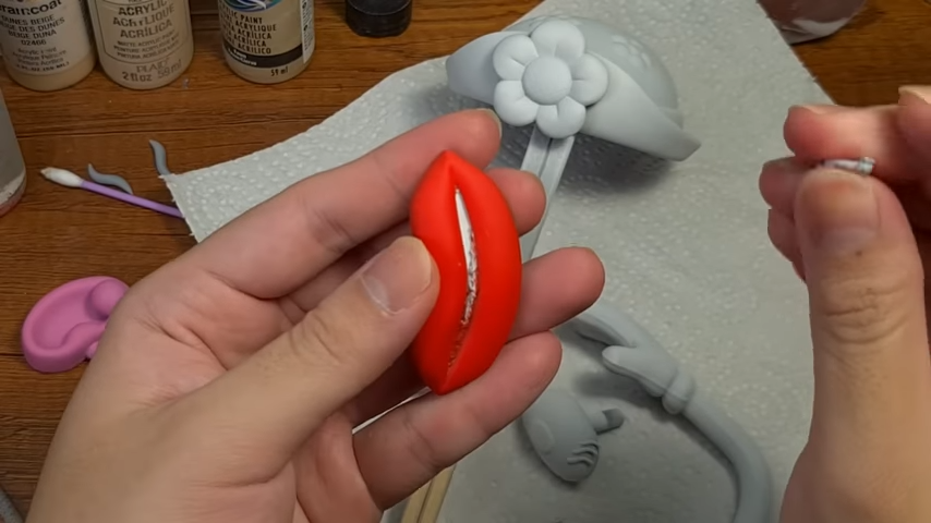 Painting the lips of Mr. Potato Head