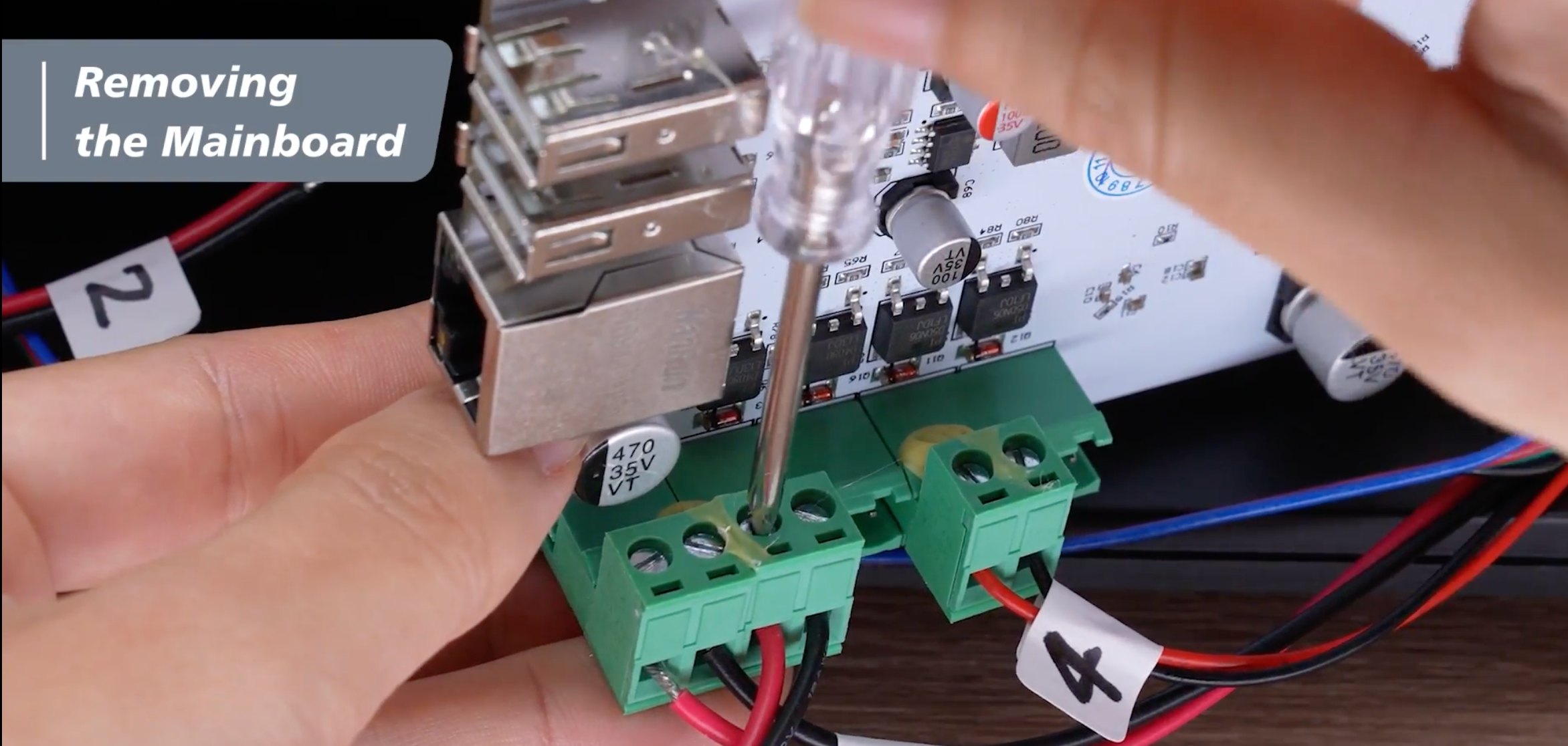 Removing the screws from the green terminal blocks