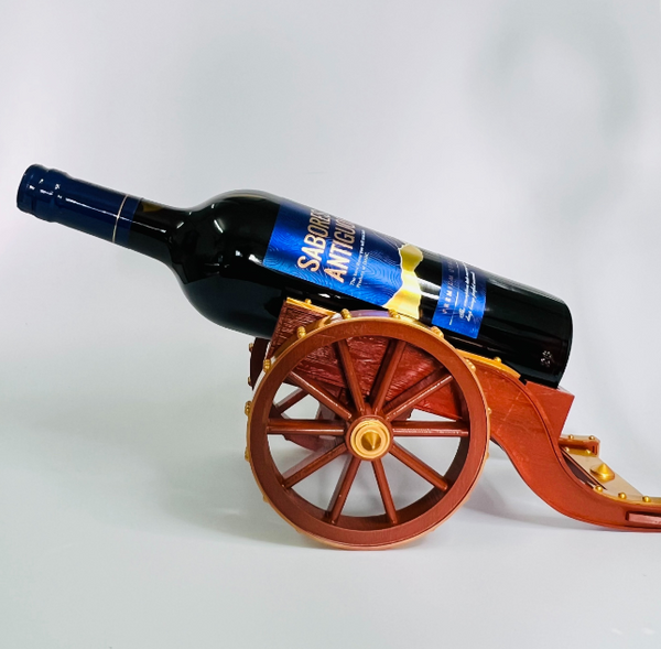 A cool 3d print of cannon wine holder with huge wheels holding a wine bottle.