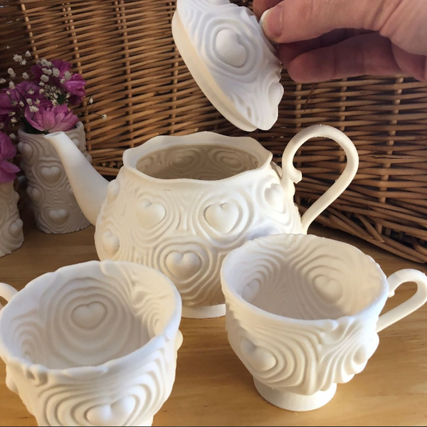Awesome 3D prints of a whimsical tea set with a heartbeat motif, great for unique home decor.