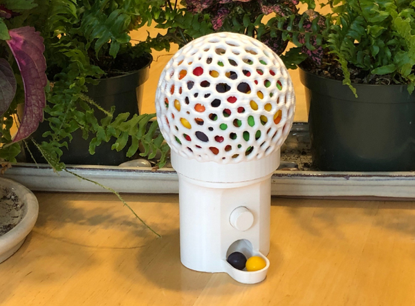 Cool 3D printed stuff of a functional gumball machine with a playful design.