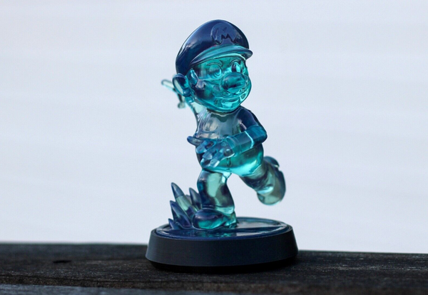 A custom 3D-printed Ice Mario Amiibo inspired by Super Mario Galaxy, featuring a transparent blue design on a circular base.