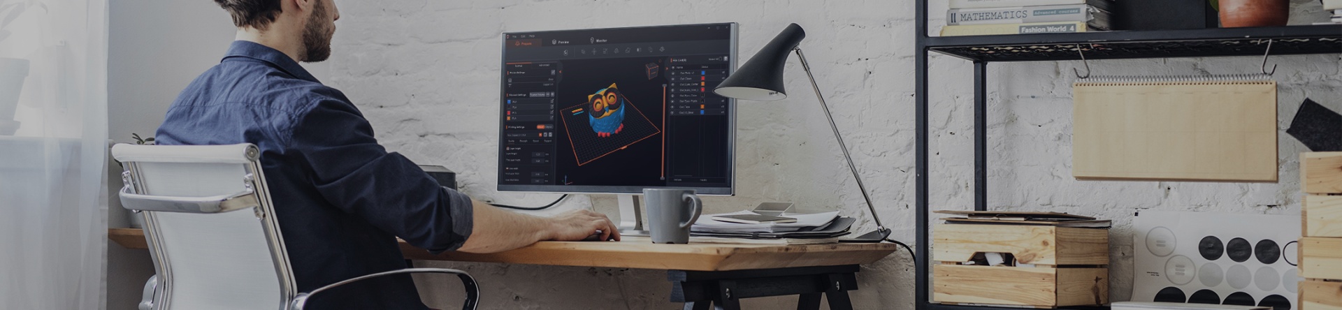 Software landing page banner with a creator working at a desk using 3D design software.