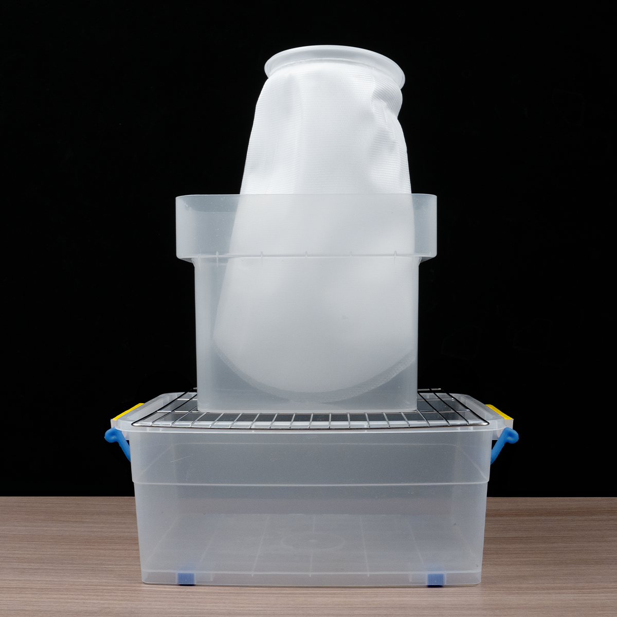 Phrozen Alcohol Filter Bag supported inside a plastic container frame, showing a practical filtration setup.