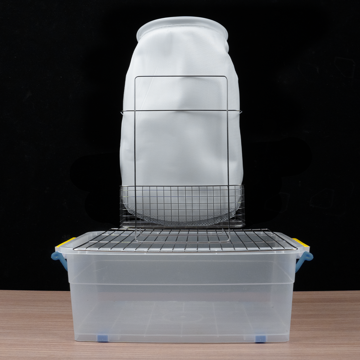 Phrozen Alcohol Filter Bag placed on a rack above a plastic collection container for drip filtration.