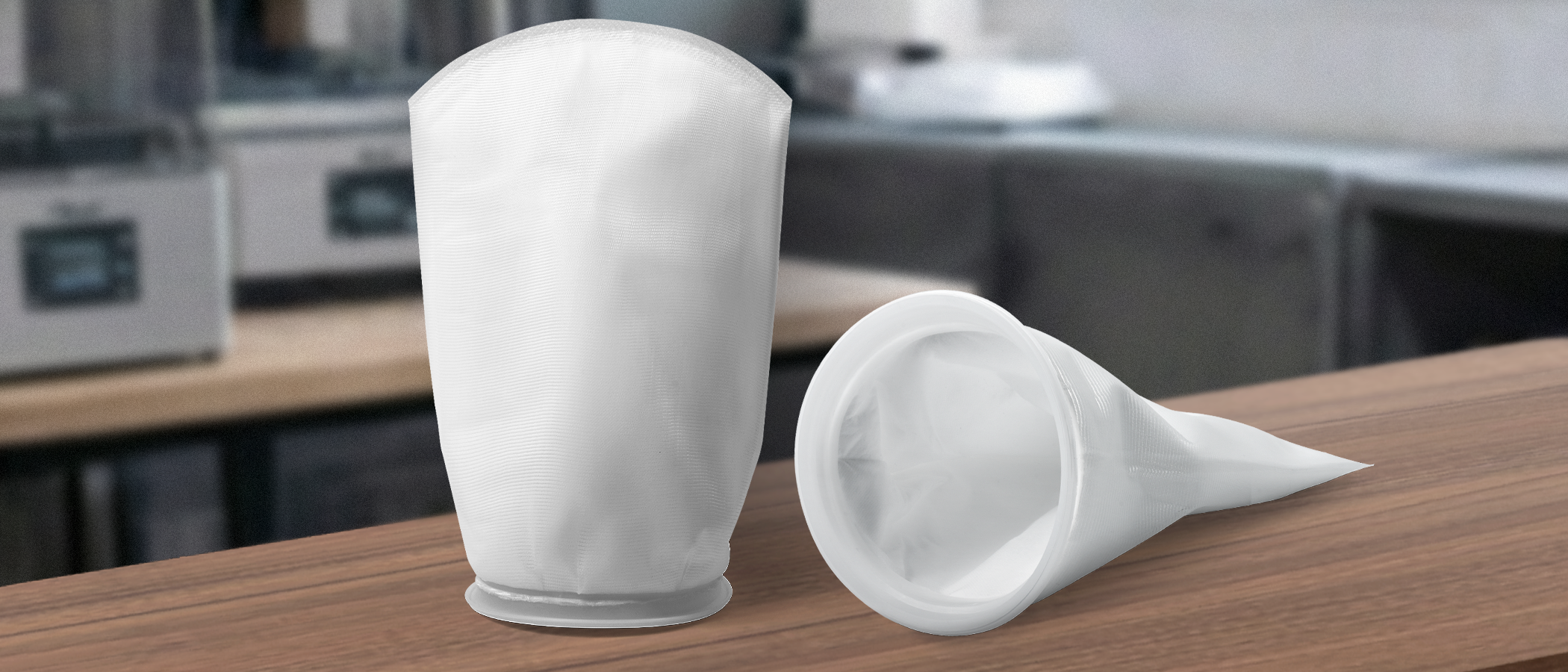 Two Phrozen alcohol filter bags on a worktable, showing the reusable filter bag designed for resin 3D printing alcohol filtration.