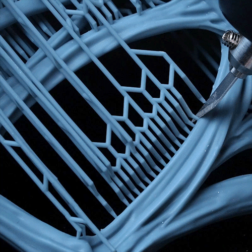 Hand using the Phrozen x MADWORKS Sonic Saber to cut resin supports cleanly without leaving marks.