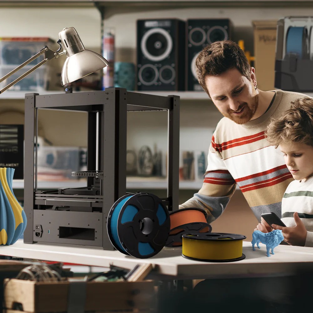 Maker and child set up an ARCO 3D printer with filament spools in a workshop.