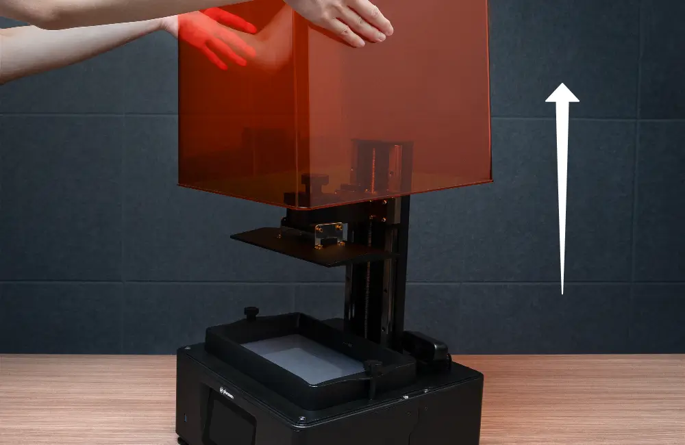 Hand lifting the printer cover straight up, showing the less convenient lid design.
