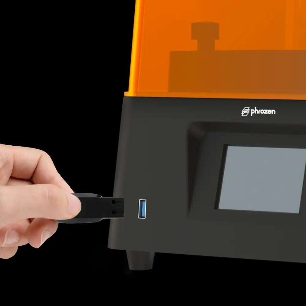 Hand inserting a USB drive into the Phrozen Sonic Mini 8K resin 3D printer for easy file access and navigation.