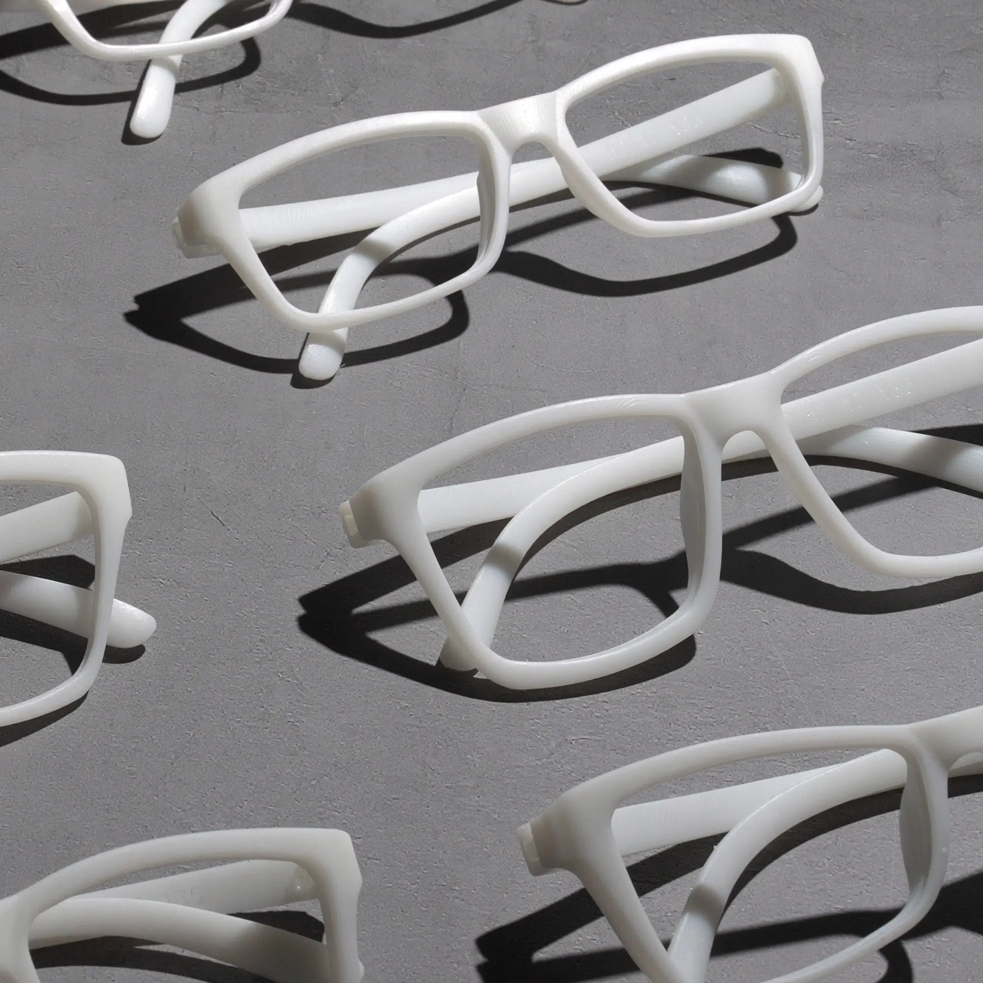 White prototype eyewear models printed with Phrozen Protowhite Tough Resin for product development and design testing.
