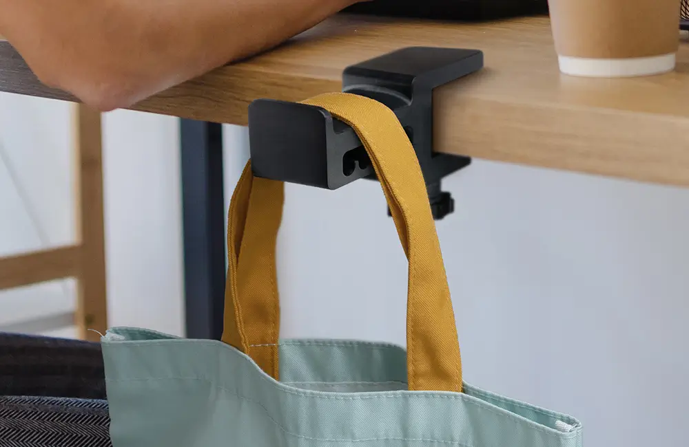 3D printed bag hook made with Phrozen x Loctite ONYX Impact Plus Resin holding a heavy bag under a desk.