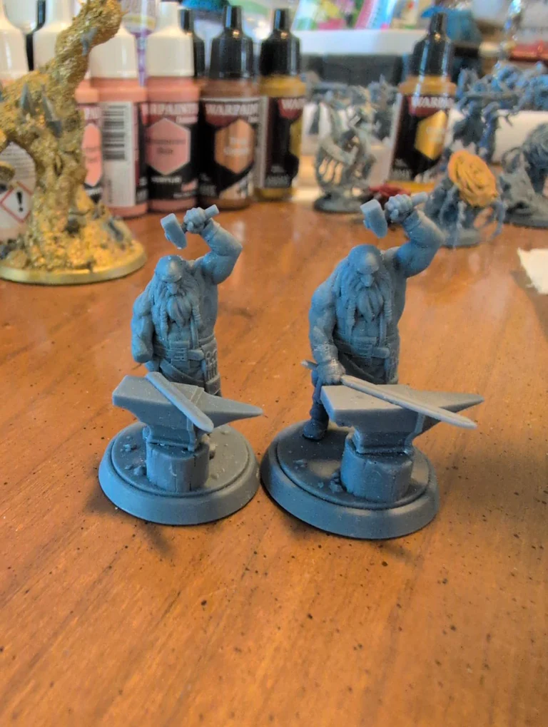 Two tabletop miniature figures printed with Phrozen RPG Resin, featured in an Amazon customer review by Genevieve.