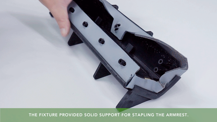 GIF of a hand stapling a 3D printed armrest, showing Tough 100E resin durability and impact resistance.